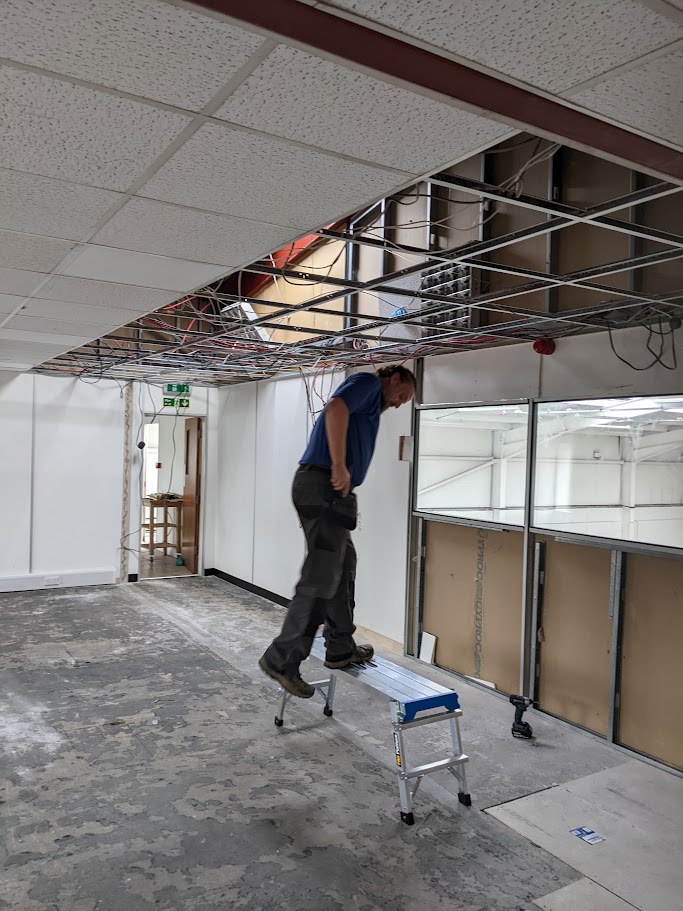 Fitting acoustic ceiling tiles into a suspended ceiling system