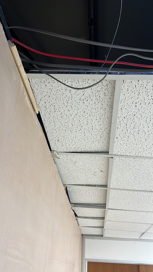 Replacing damaged ceiling tiles in an office suspended ceiling