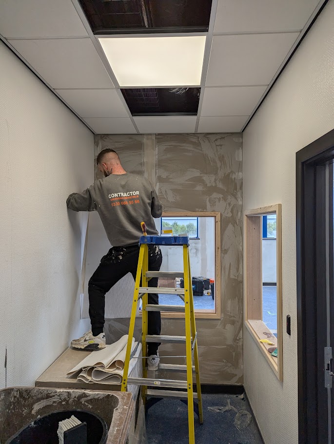 Contractor hanging wallpaper