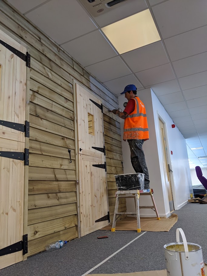 Applying protective wood treatment to timber surfaces in a commercial setting in Sheffield