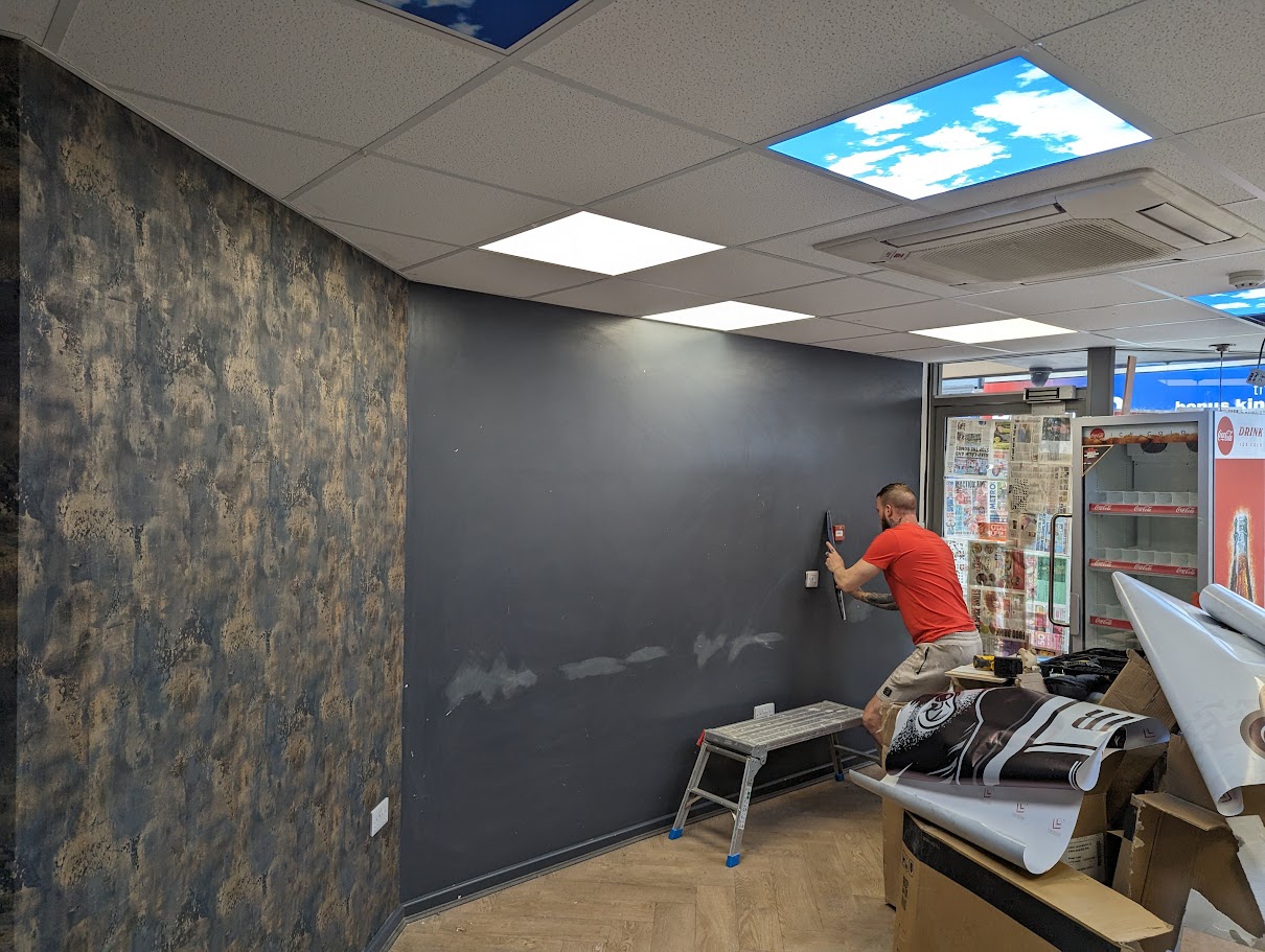 Installing contract vinyl wallcovering in a commercial corridor in Sheffield