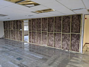 Installing insulation inside commercial partition walls