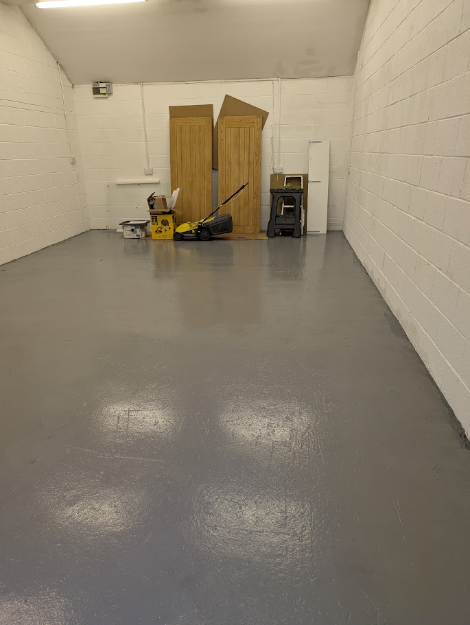 Applying a durable epoxy floor coating system in an industrial unit