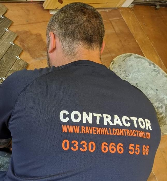 Contractor installing tiled flooring