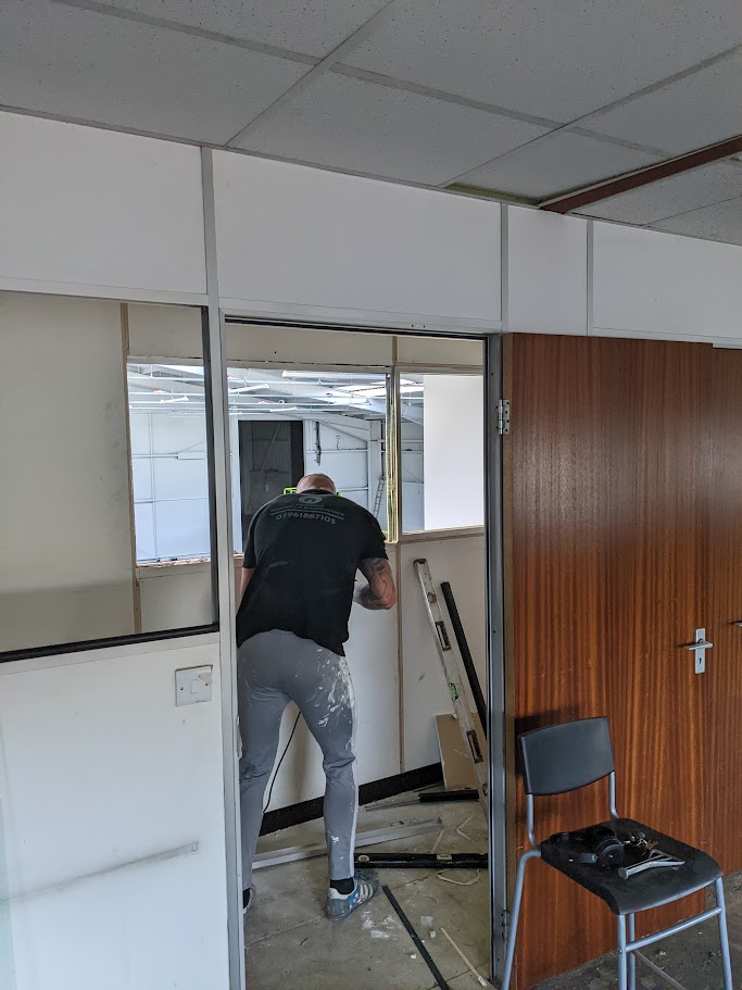 Contractors installing partition walls during an office fit out project in Sheffield