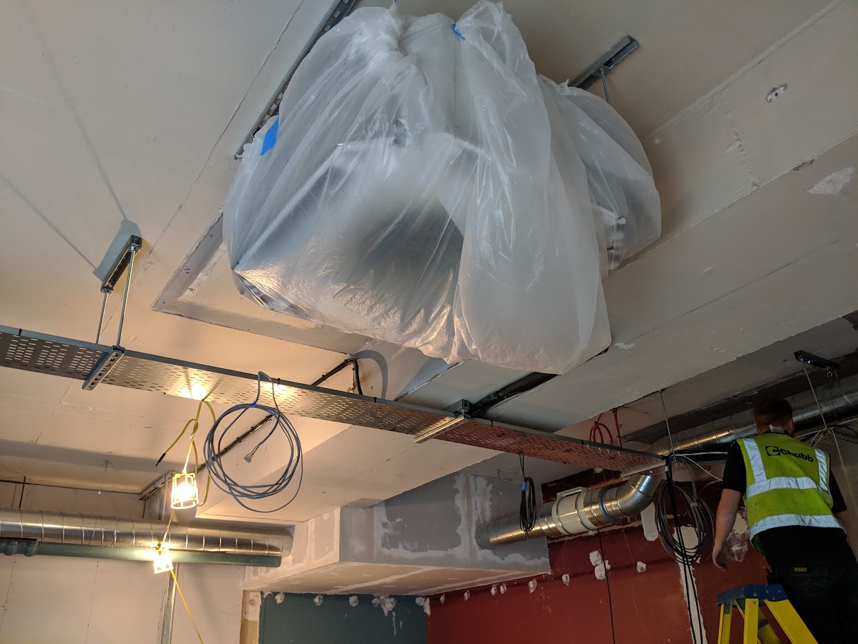 Masking and protection set up before spray painting in a commercial unit